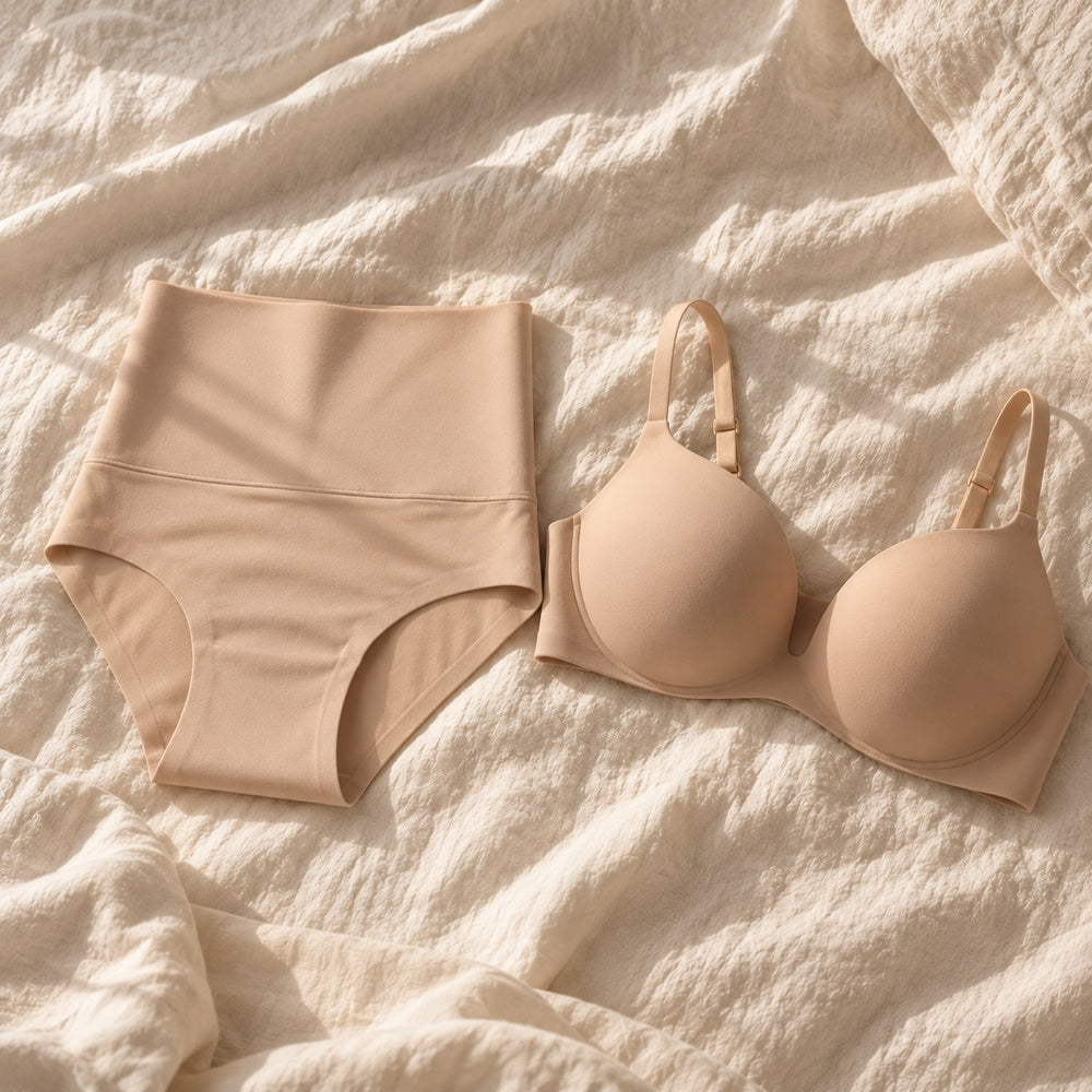 The two pieces of the brand side by side on cream linen: the high-waist brief and the seamless push-up bra
